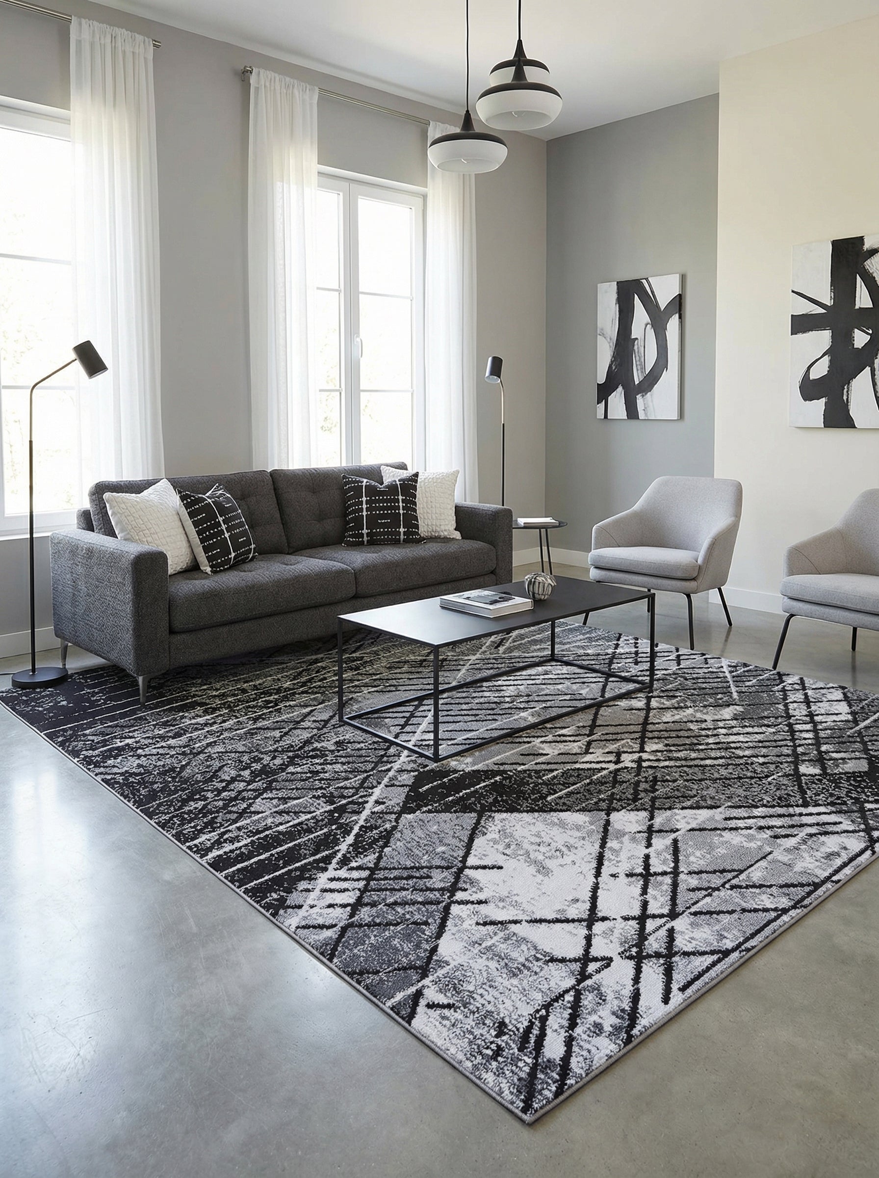 Tapis rectangulaire à motifs graphiques géométriques noirs, gris et blancs avec un effet texturé, dans un salon contemporain