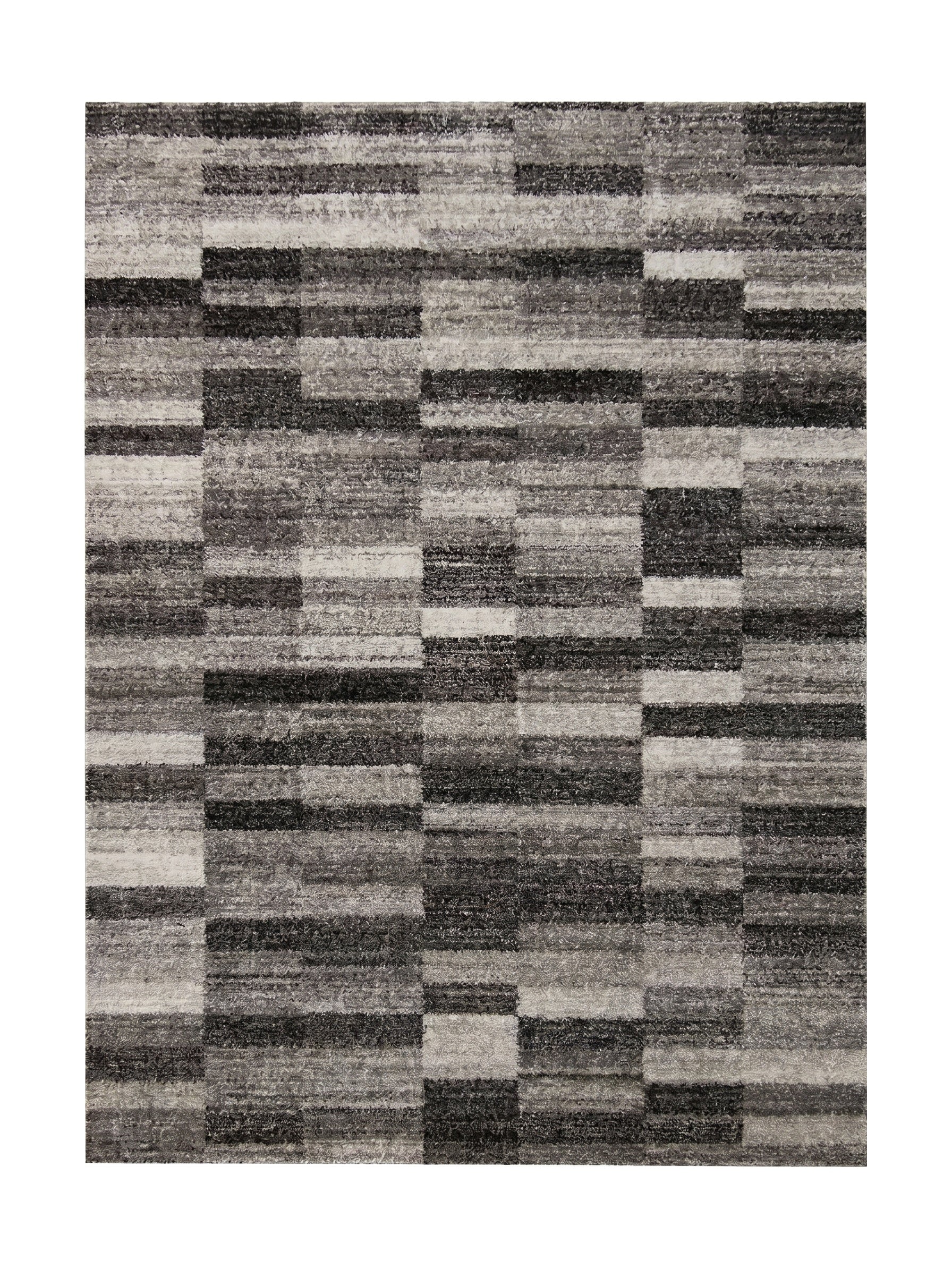 Tapis rectangulaire à motif géométrique de blocs et bandes. Teintes de gris, anthracite et blanc cassé. Texture fibreuse