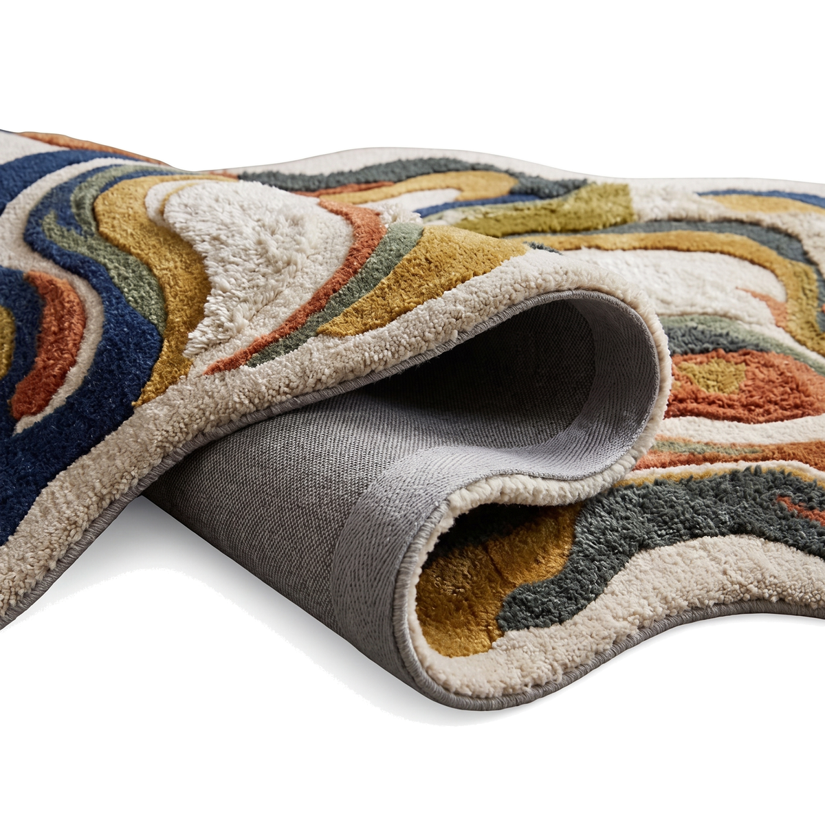 Le tapis en laine et viscose révèle sa texture sculptée, son dos gris et sa tranche épaisse aux bandes multicolores