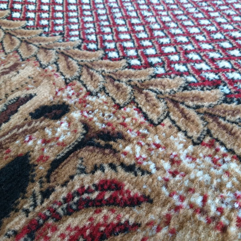 Tapis textile aux motifs floraux beiges, bruns, noirs et rouges, complétés par un quadrillage de fibres rouges et blanches