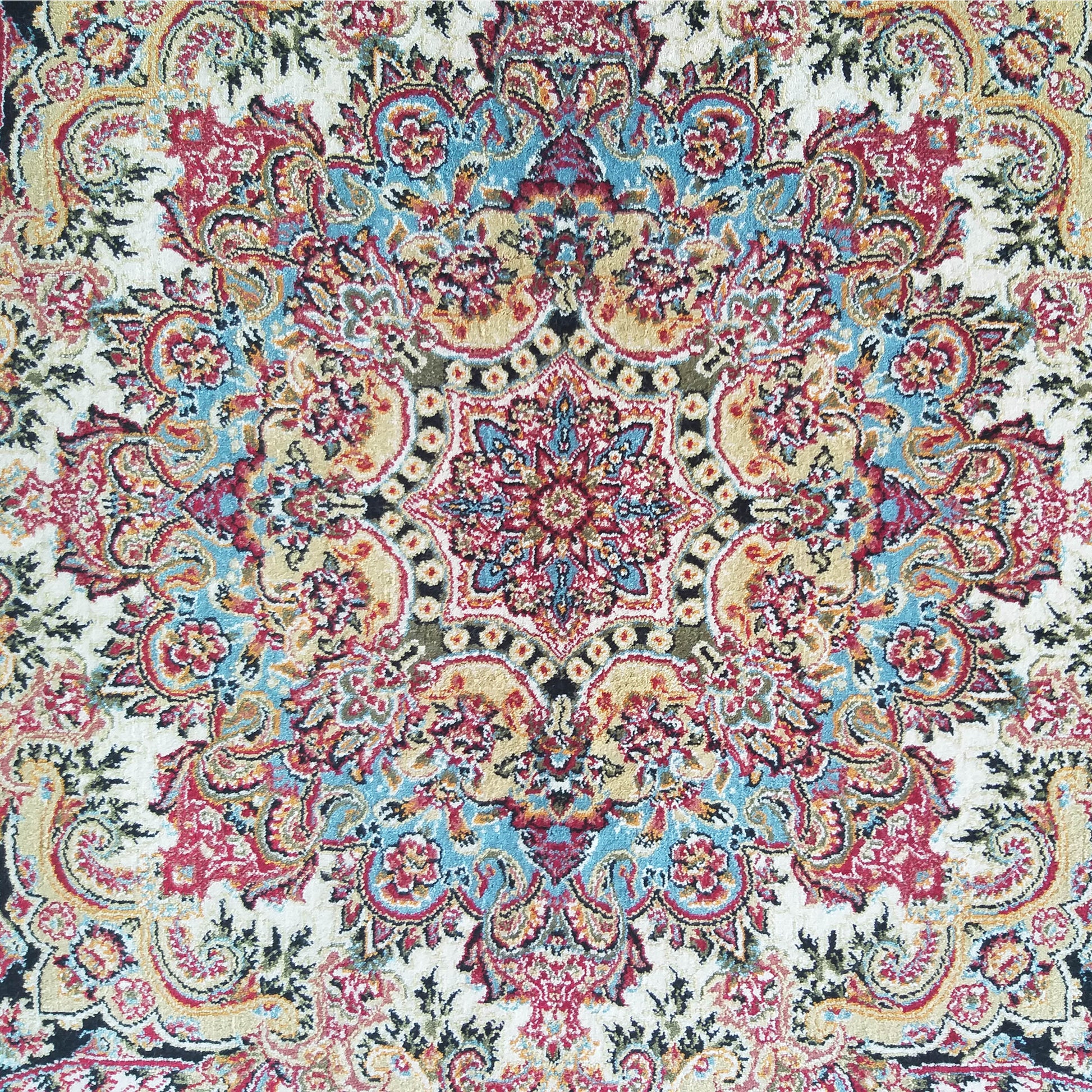 Tapis à motifs orientaux colorés, avec un dessin central en médaillon et des ornements floraux rouges, bleus, beiges et dorés