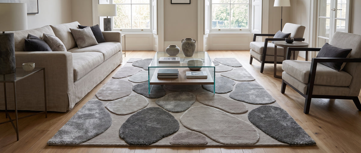 Le poil coupé de la viscose et de la laine forme des galets gris et taupe sur ce tapis de salon